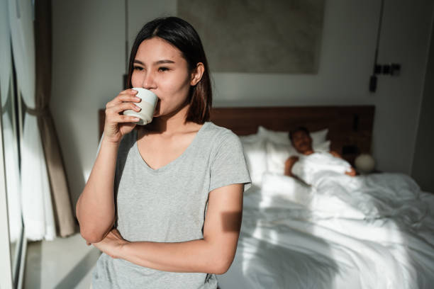 istock Woman is drinking coffee by the window in morning 1434951168
