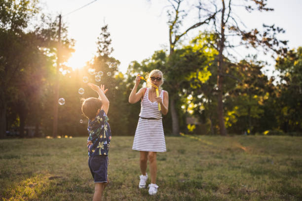 istock Mother blowing bubbles with her two sons 1434951913