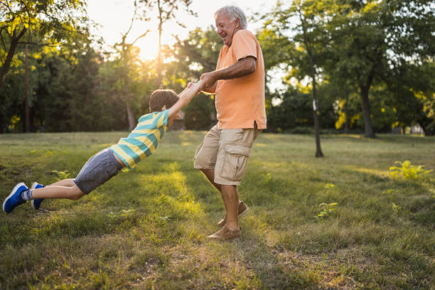 istock Grandfather playing with his grandson in a public park 1434952010