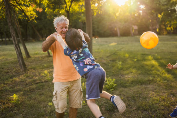 istock Grandfather playing with his grandson in a public park 1434952132