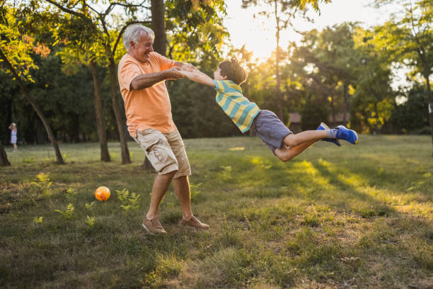 Grandfather playing with his grandson in a public park