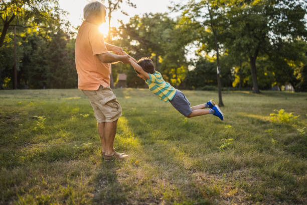 istock Grandfather playing with his grandson in a public park 1434952529