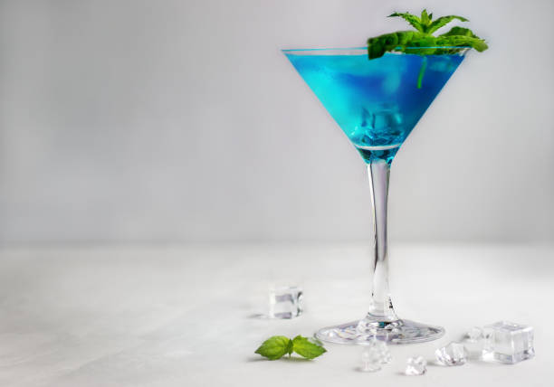 istock Blue cocktail in martini glass with ice cubes and mint 1434952782