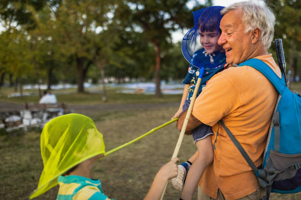 istock Kids playing with butterfly nets in a public park 1434952905