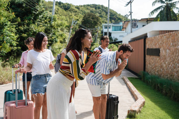 istock Group of tourists greeting their host 1434953733