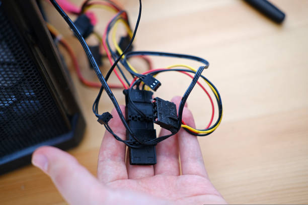 istock A man repairs a cable in a system unit and connects electrical wires 1434955050