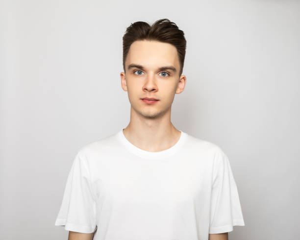 istock Young man wearing white tshirt studio shot on gray background 1434955404