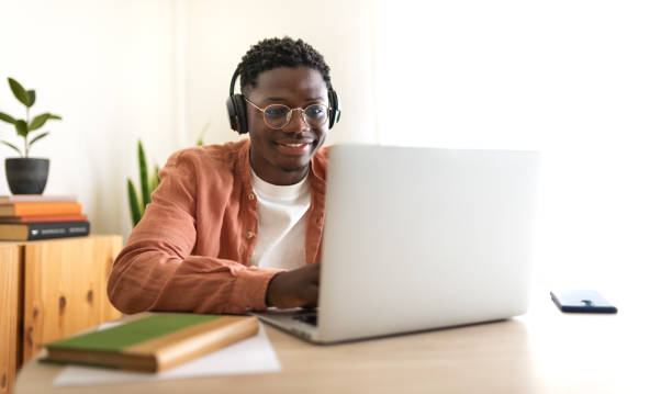 istock E-learning concept. Teen African American college student taking online lessons.Panoramic image. 1434959531