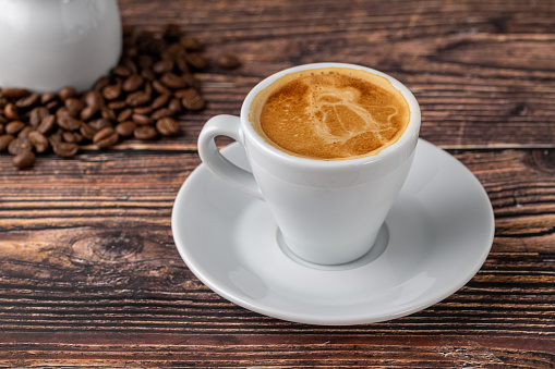 Pouring Milk into Fresh Coffee