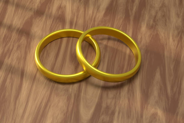 Golden Wedding Rings On The Wooden Table