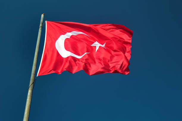 Turkish flag against blue background stock photo