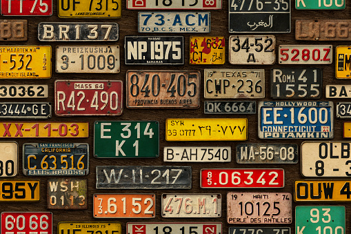Various retro License Plates on the wooden wall. Seamless pattern.