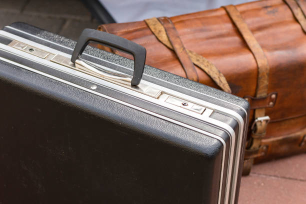 istock Old plastic suitcase on the background of a leather bag 1434965443