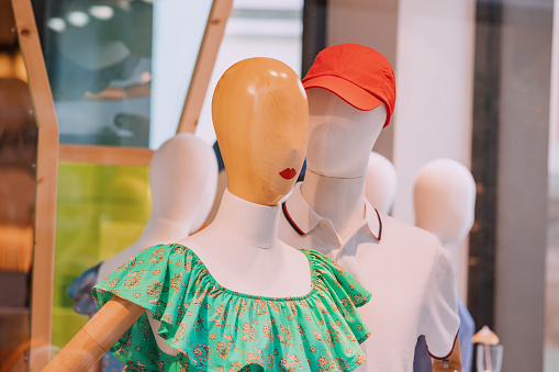 Couple of mannequins in fashionable clothes are tender hugging. Shopping and leisure concept. Relationship and love.