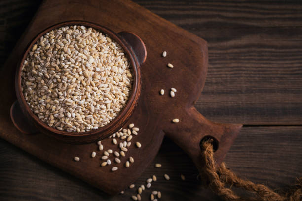 istock Organic uncooked dried barley cereal grain in a bowl 1434966637