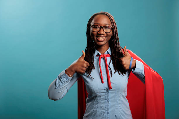 istock Positive smiling heartily justice defender wearing mighty hero red cape while giving approve sign. 1434971112
