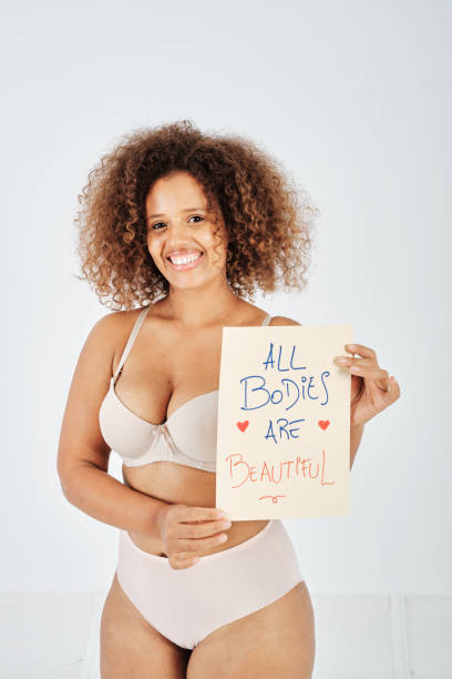 ethnic female in underwear showing body positive placard - panties underwear transparent women imagens e fotografias de stock