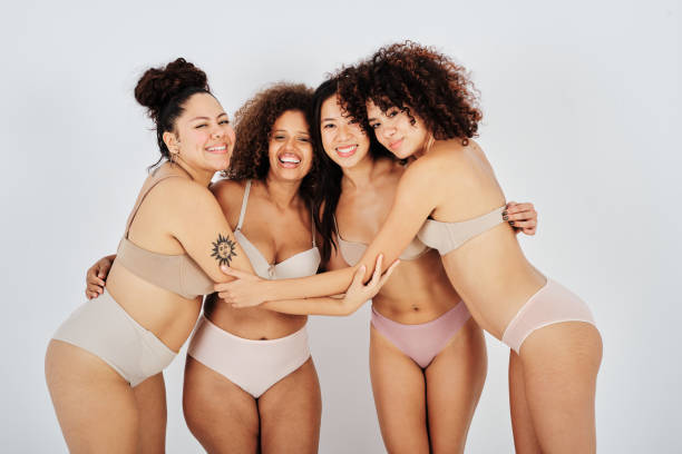 istock Cheerful diverse women in underwear hugging in studio 1434977537
