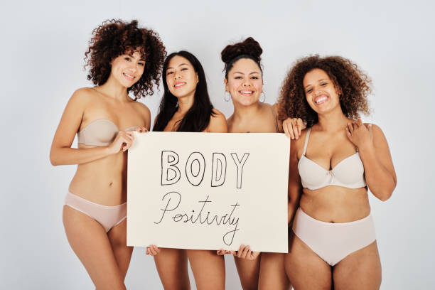 istock Group of merry girlfriends with Body Positivity placard 1434977816