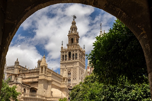 The Giralda tower and the cathedral of Seville framed by an arch, Spain