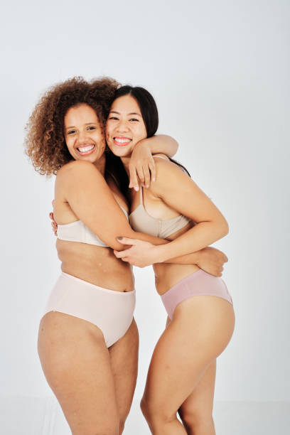 istock Merry diverse girlfriends in underwear hugging each other 1434977913