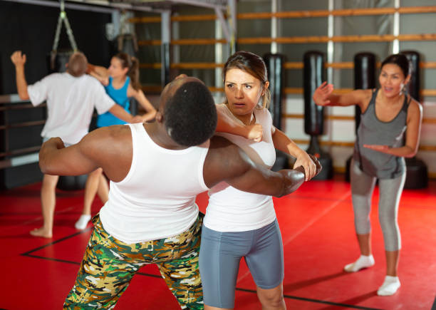 istock Men and women exercising during self-defence training 1434979512
