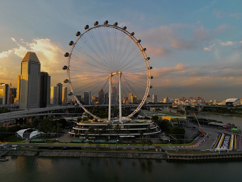 Singapore, Singapore – October 12, 2022: An aerial shot of the Singapore Flyer surrounded by modern buildings at sunset