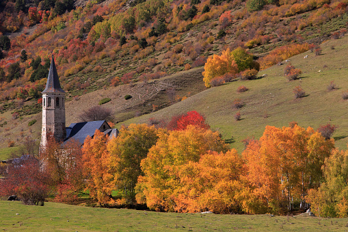 The Montgarri sanctuary in autumn with the colours of the trees red, yellow, orange. A quiet place of la vall d’aran that you can be accessed througth el Pla de Beret.