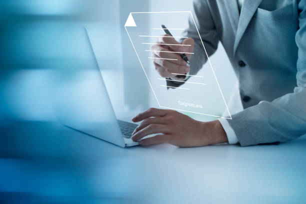 istock Businessman, work from home, handling documents, E-signing, signing digital contracts electronic signing electronic signature through internet technology document data management smart contract 1434984105
