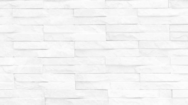 istock Seamless texture of white brick stone wall a rough surface, with space for text, for a background.. 1434986777