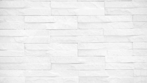 istock Seamless texture of white brick stone wall a rough surface, with space for text, for a background.. 1434986800