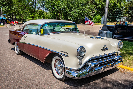 Falcon Heights, MN - June 19, 2022: High perspective front corner view of a 1954 Oldsmobile 98 Holiday Hardtop Coupe at a local car show.