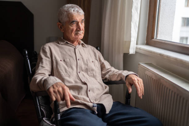 istock Contemplative Senior Man Looking Through The Window 1434989982