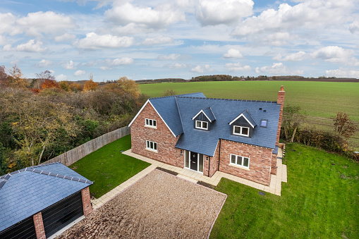 Cowlinge, Suffolk, England - 17 November 2017: Brand new detached family home just recently constructed and finished in the suffolk countryside just outside Newmarket in charming picturesque setting - aerial view