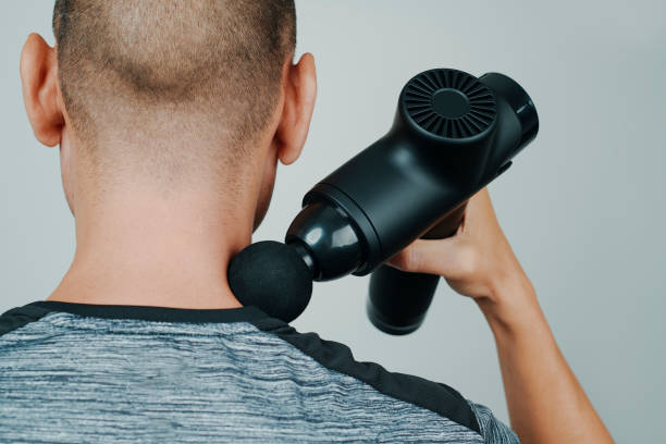 istock sportsman using a massage gun on his neck 1434996225