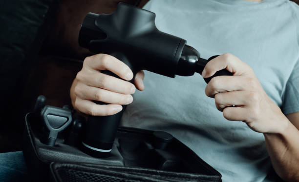 istock man about to use a massage gun, banner format 1434996627