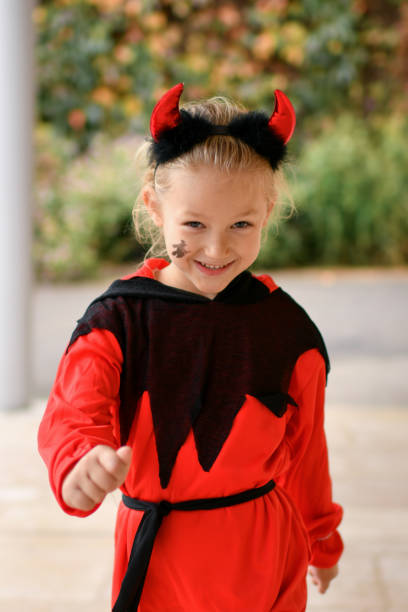 istock A girl dressed as a devil with horns 1434997034