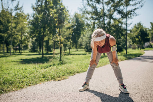 istock Senior woman resting after jogging 1435001463