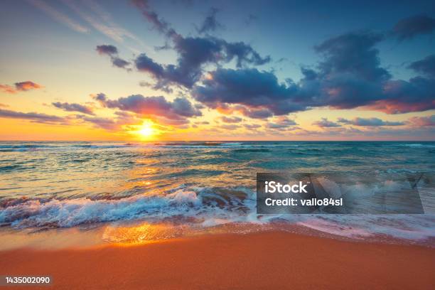 Beautiful Sunrise Over The Sea Waves And Beach On Tropical Island Beach Stock Photo - Download Image Now