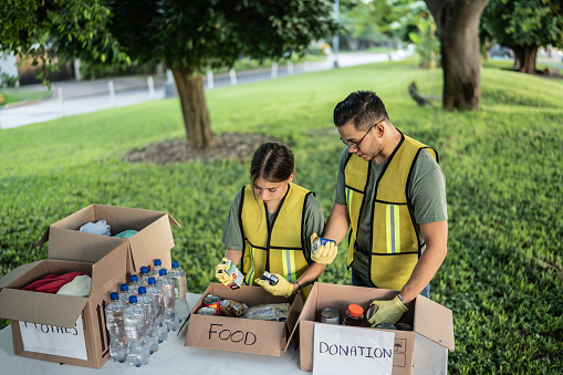 Volunteers organizing the foods to donation at a public park