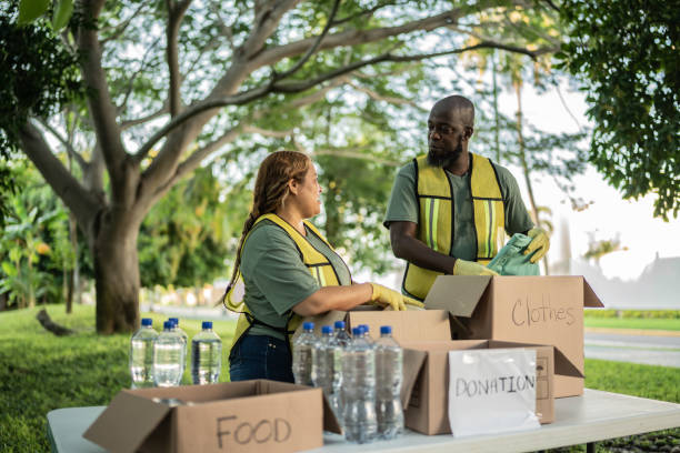 istock Volunteers talking while organizing the clothes to donation at public park 1435002476