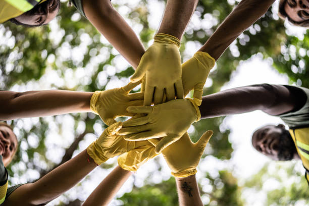 Close-up of stack of hands outdoors