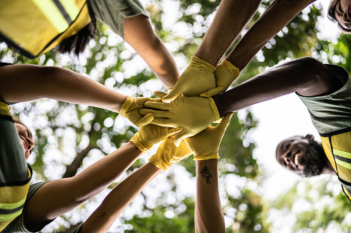 Close-up of stack of hands outdoors