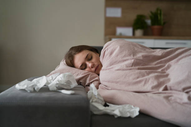 Sleeping caucasian woman during the illness stock photo