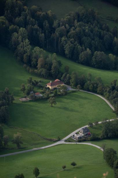 istock Single, countryside house surrounded by pasture and dense forest, aerial, vertical 1435005901