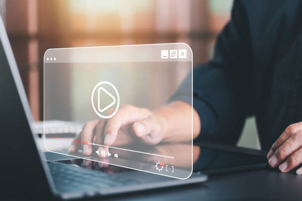istock young man using laptop to watch video,Training, learning, teaching, virtual reality used in online video conferencing,Online streaming Watch videos on the Internet 1435006091