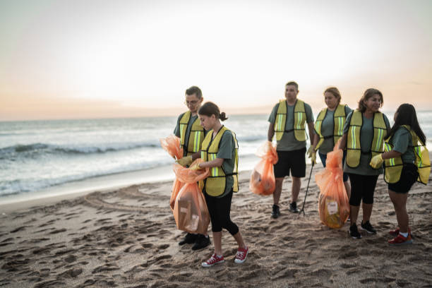 istock Recyclers walking on the beach 1435006201