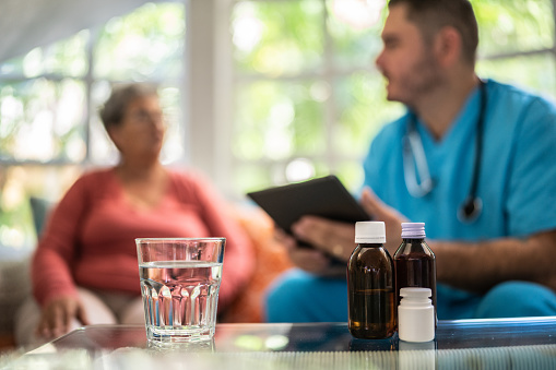 Close-up of medicines and glass of water