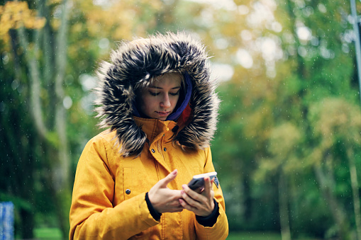 Portrait of a teenage girl in public park on a rainy Autumn day.
Canon R5