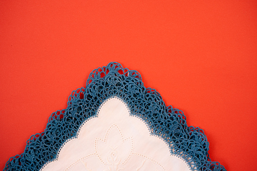 Cotton handkerchiefs with embroidery and crochet blue lace on red Background